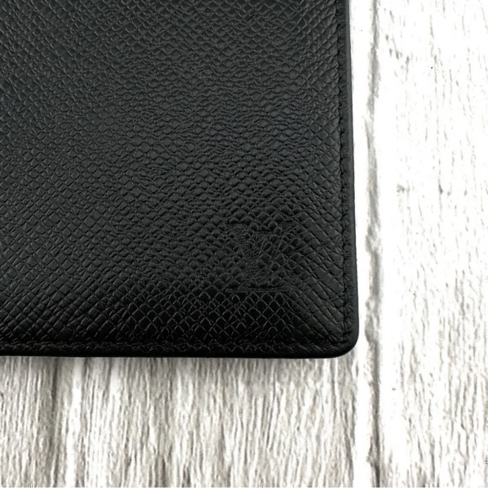 AUTHENTIC Louis Vuitton Taiga wallet. Previously owned. Color: Black.